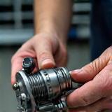 Technician repairing a fishing reel